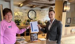 Rotarian Christine Sheldon, organiser of the charity Easter Egg raffle with Reception Supervisor Daniela at the Crown Ampney Crucis.
